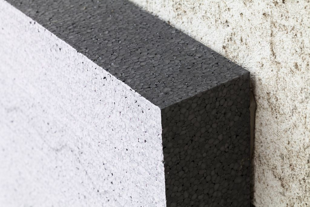House building being insulated with polystyrene filled with graphite